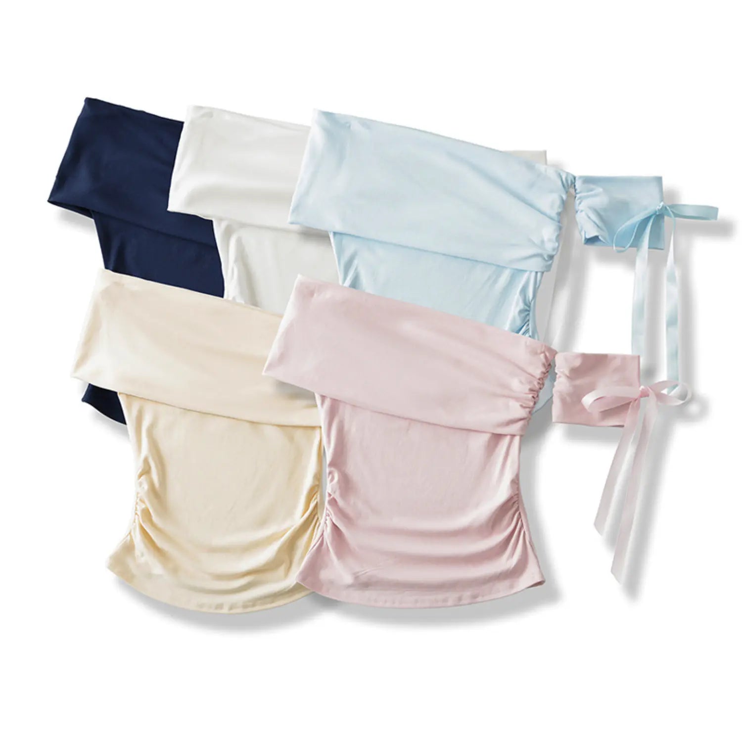 Flat lay of multi-color off shoulder ruched crop tops with matching detachable satin bow sleeves, white beige pink light blue navy color collection