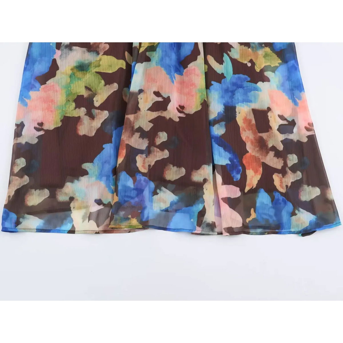 Macro shot of vertical pleated chiffon fabric with vibrant watercolor floral print
