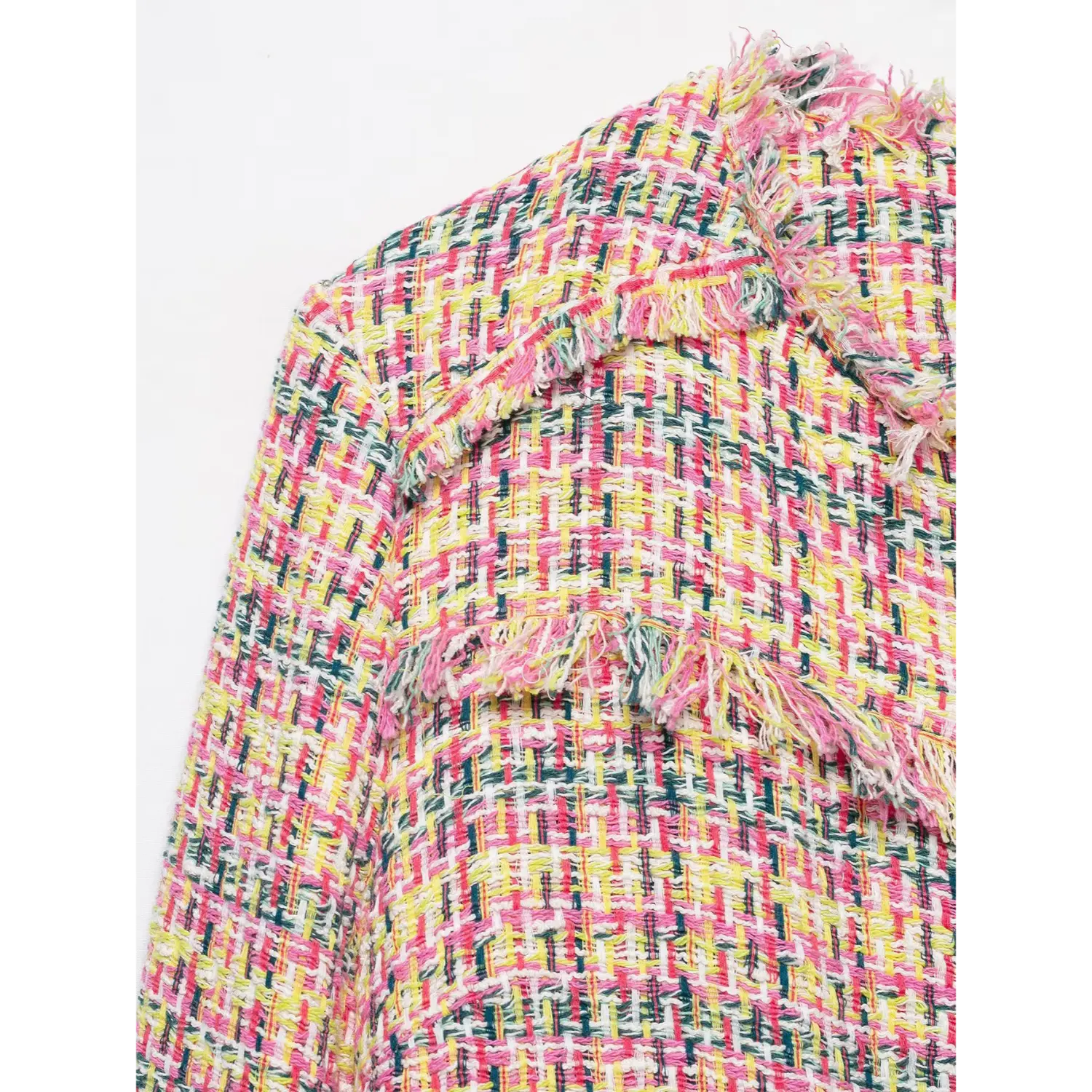 Close-up texture multicolor pink yellow green woven tweed fabric with frayed trim