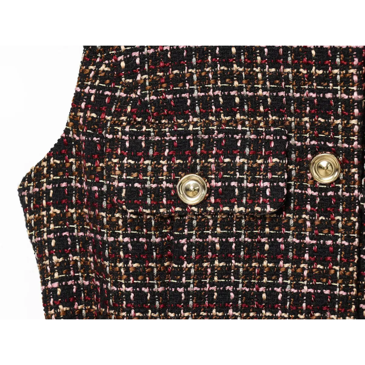 Close-up of the patch pocket on the tweed tunic, showing the gold button and textured fabric weave
