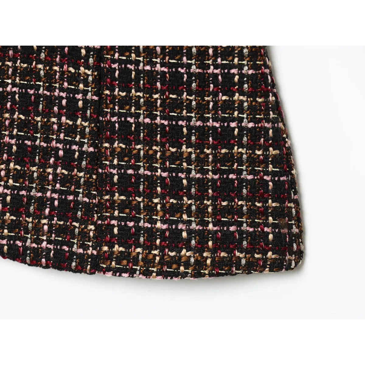 Close-up of the lower hem, showing the clean edge and intricate multicolor tweed pattern