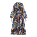 Front view of multicolor watercolor pleated maxi dress, high neck, long balloon sleeves, drawstring cuffs, fitted waist and flowing long skirt