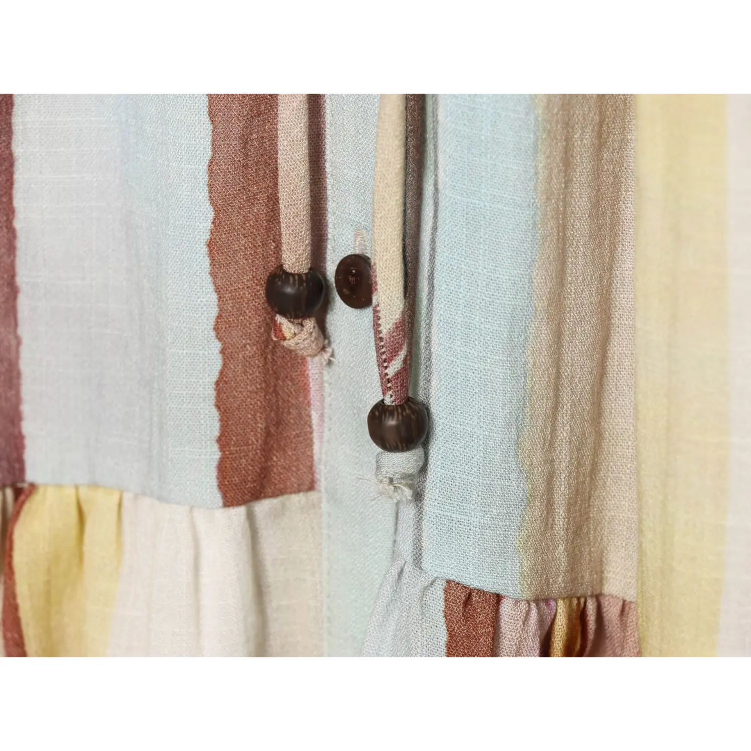 Close‑up view of decorative front buttons and stripe fabric