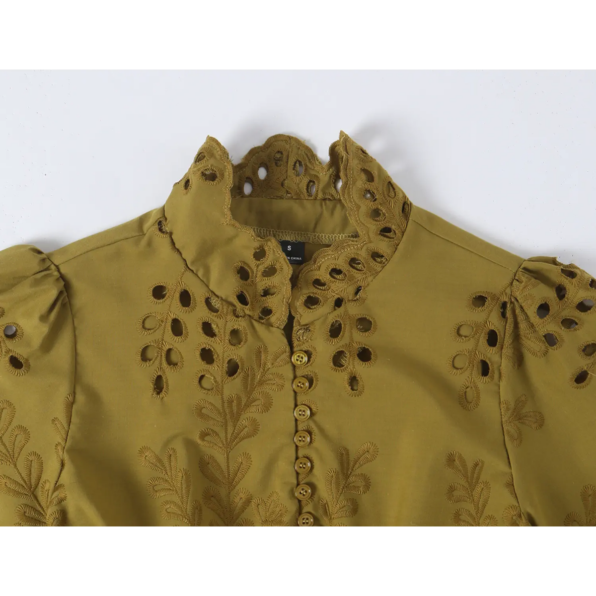 Close-up of scalloped collar and front buttons