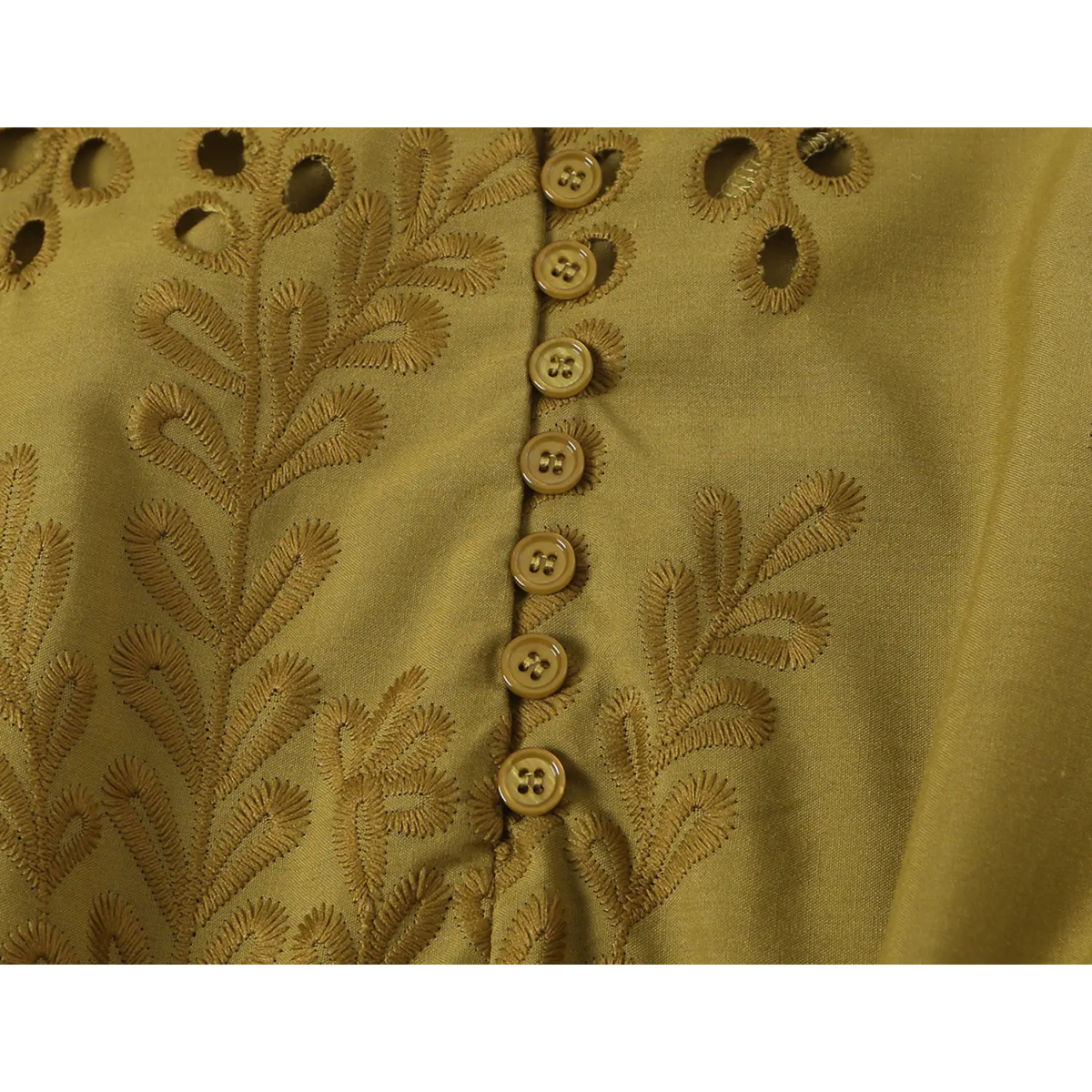 Close-up of front button placket and leaf embroidery