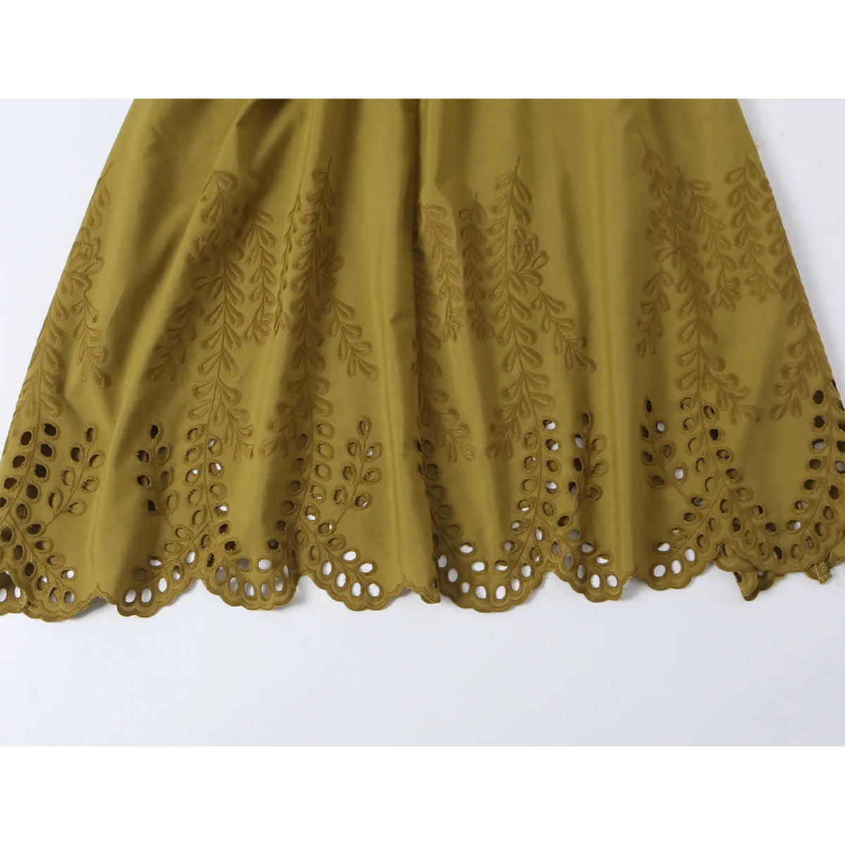 Close-up of scalloped eyelet hem
