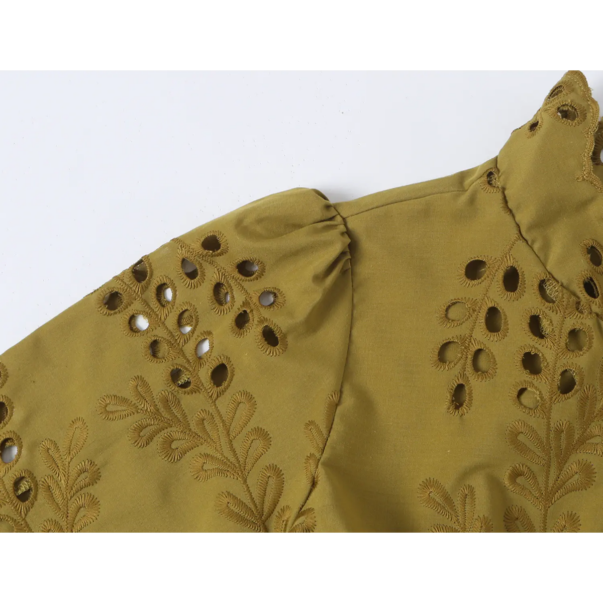Close-up of gathered shoulder and eyelet embroidery