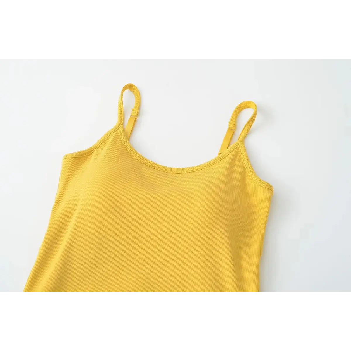 Partial front view of the mustard yellow ribbed camisole, showing scoop neckline and adjustable straps