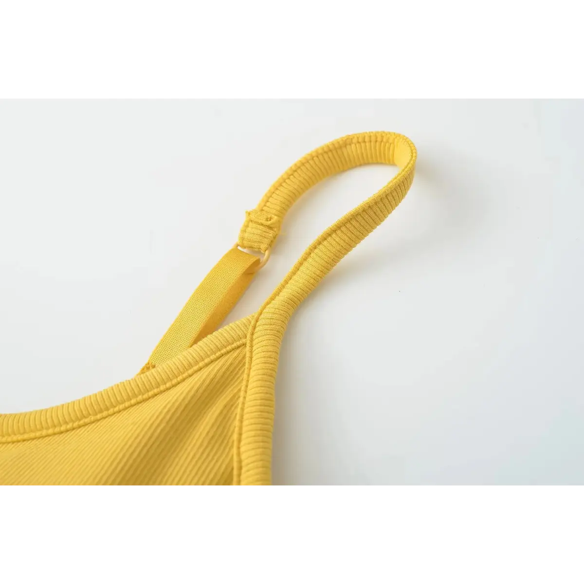 Close-up of the removable, contoured bra pad inside the mustard yellow camisole