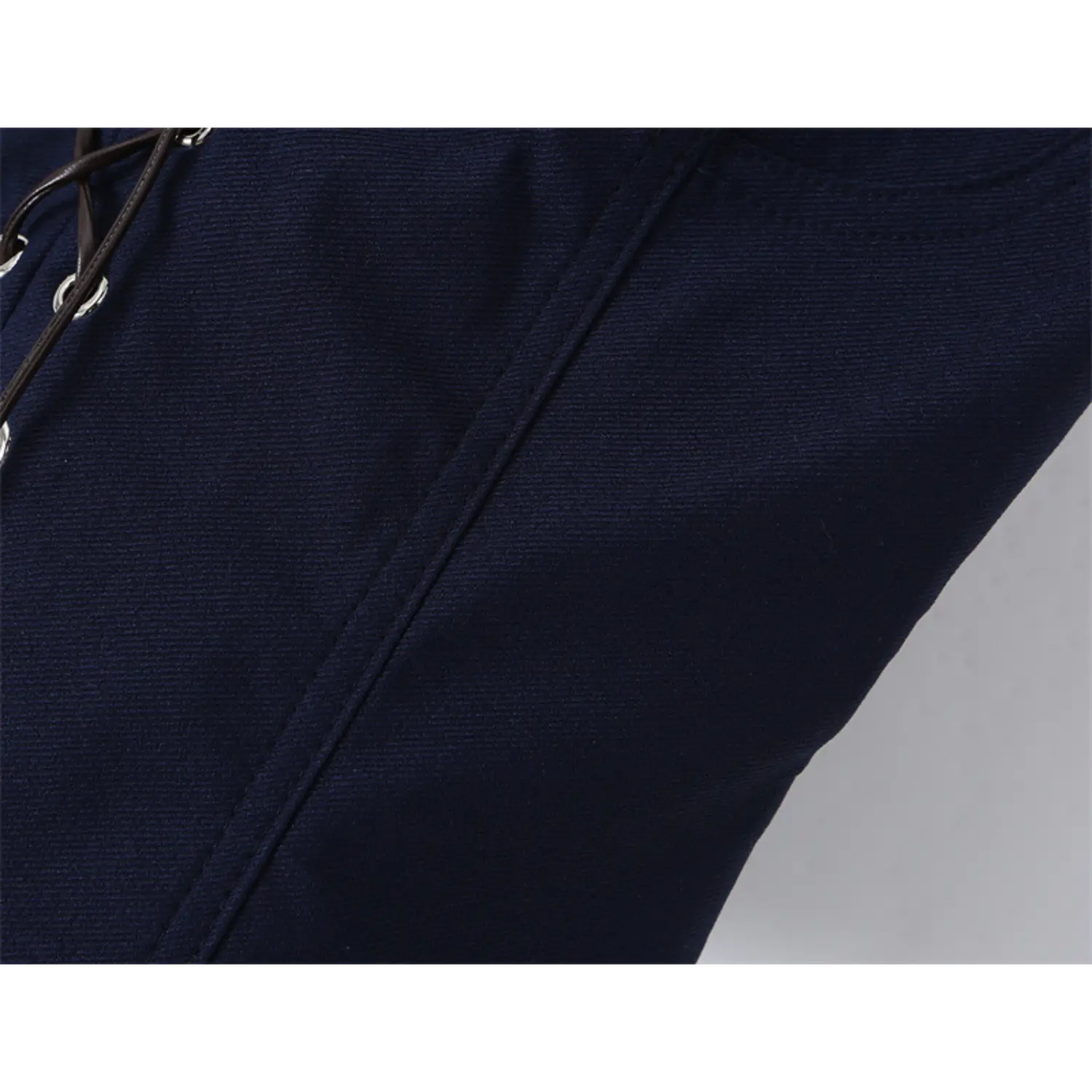 Close-up of the twill fabric texture on the navy blue corset-style top
