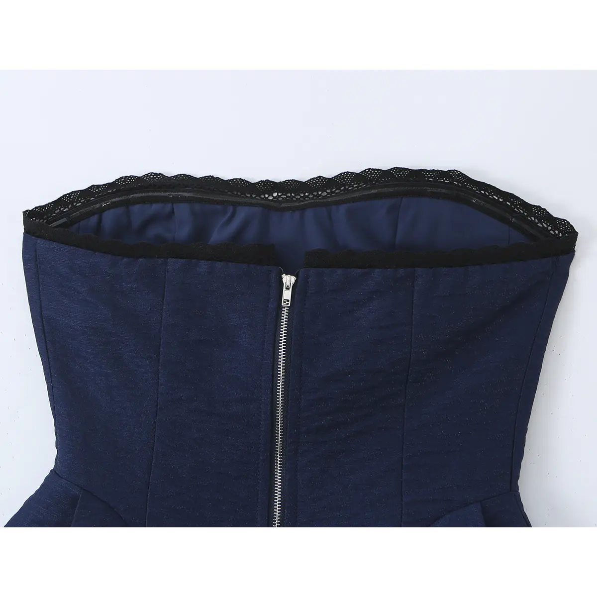 Close-up of the center-back zipper and the lace-trimmed top opening.