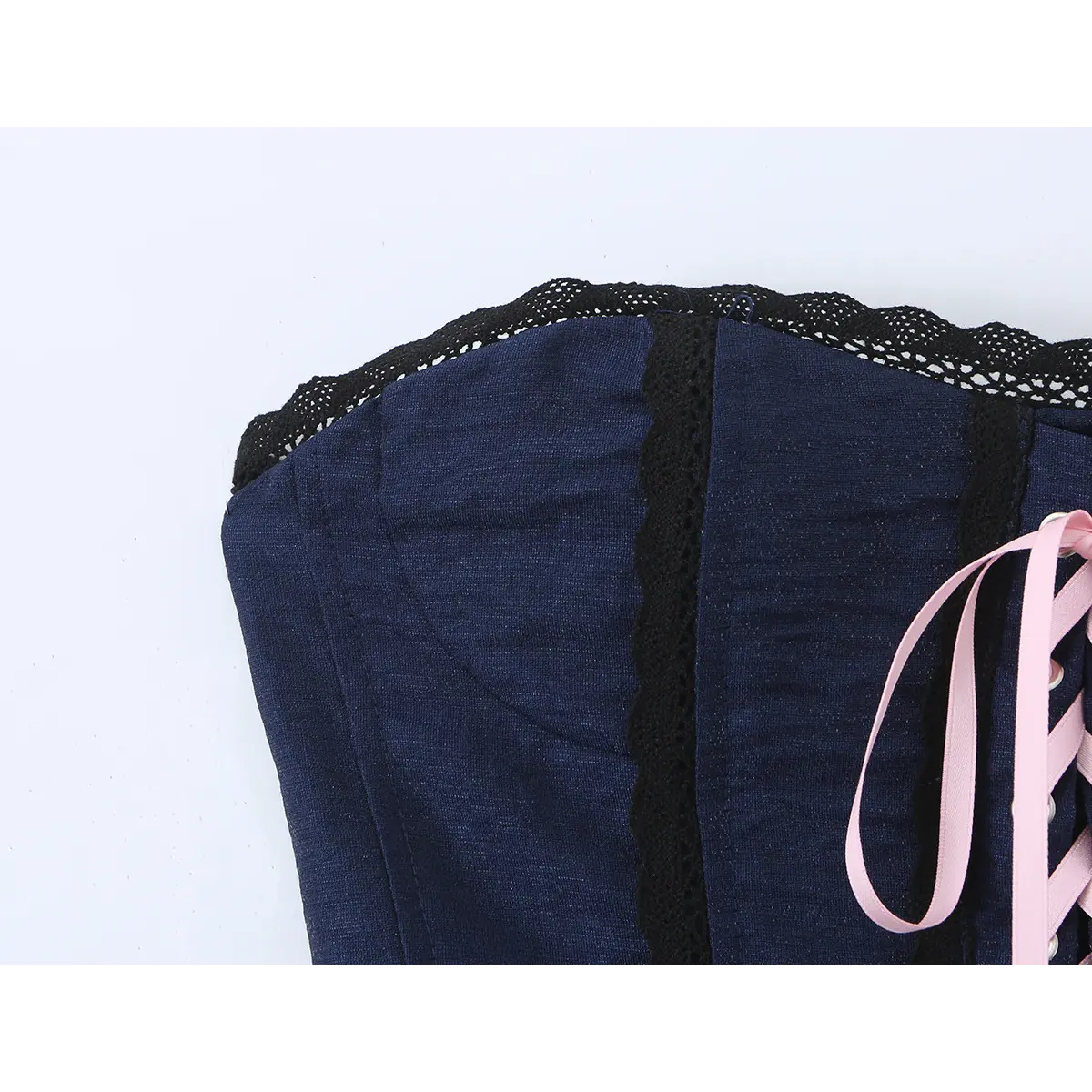 Full front view of the corset top, featuring lace-up front, scalloped lace trim, and peplum hem.