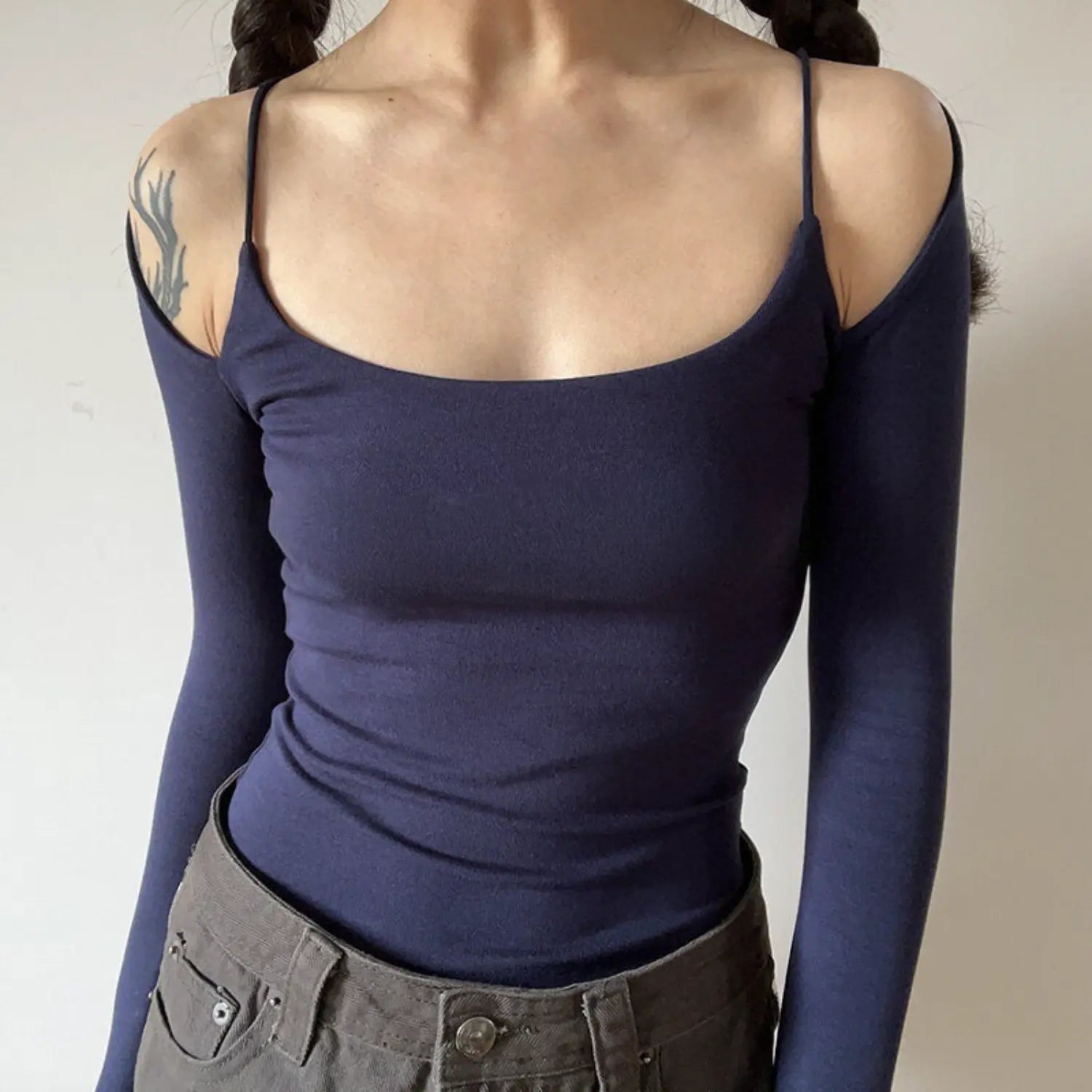 Navy blue spaghetti strap off shoulder long sleeve top half body indoor shot, slim waist cropped square cold shoulder low-key slim commuter soft top
