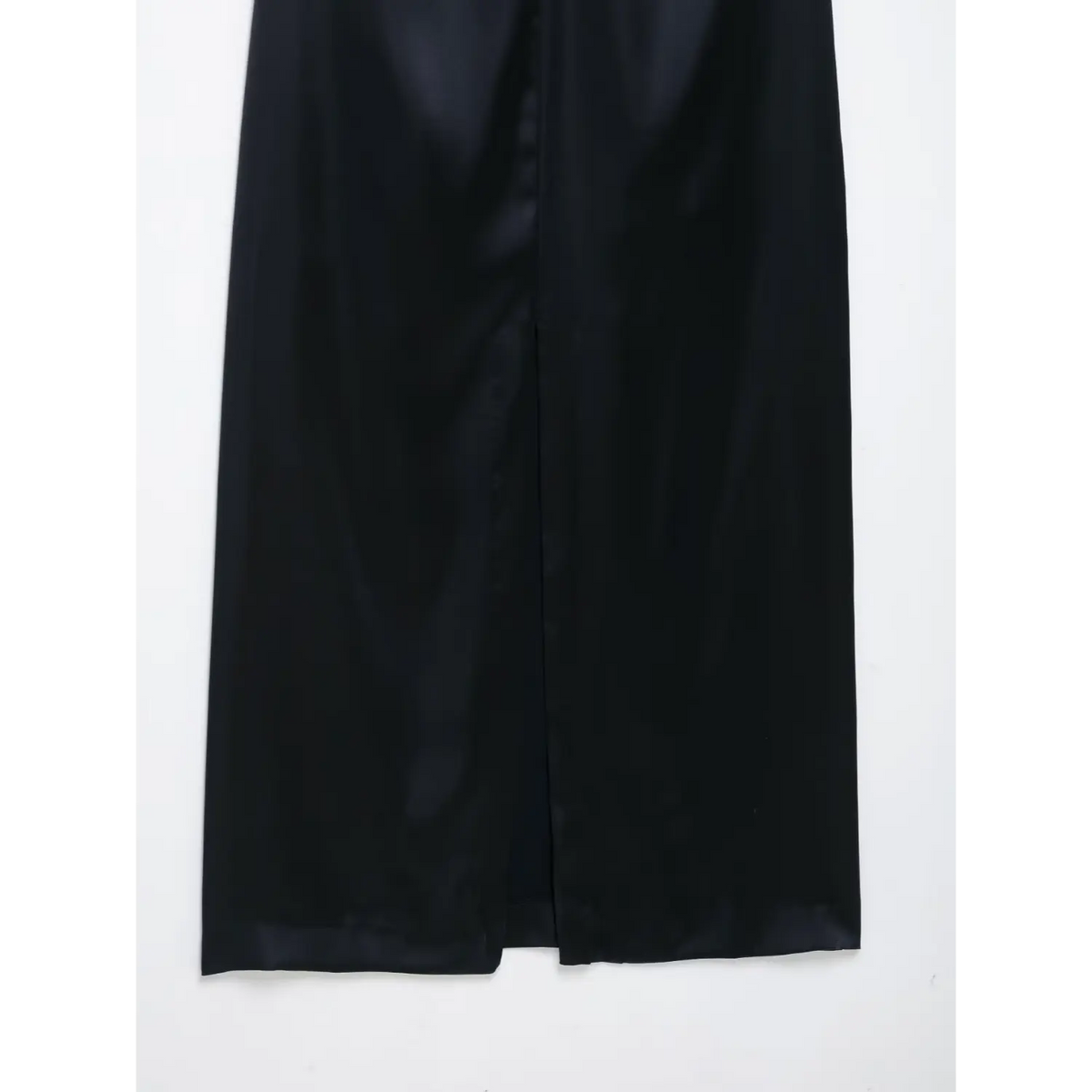 Close-up of back slit at hem of navy blue satin maxi dress