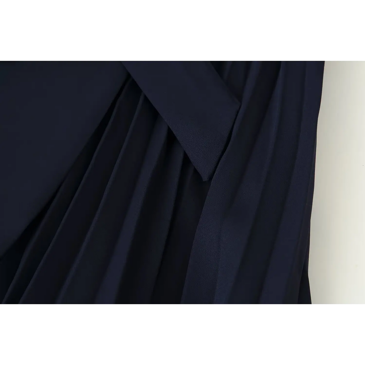 Close-up of peplum layer and pleated skirt junction
