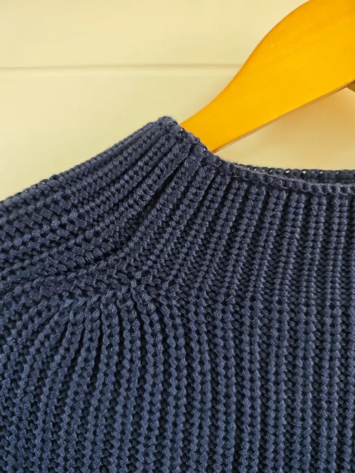 Close-up of mock neck ribbing and shoulder seam