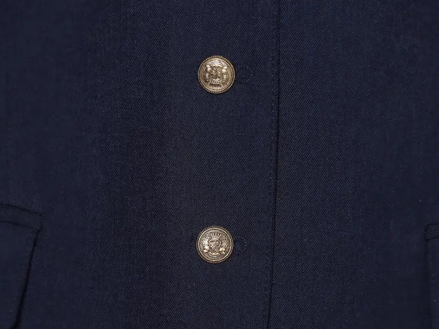 Macro close-up of gold crest buttons