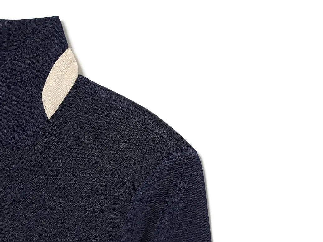 Close-up of stand collar with cream contrast trim