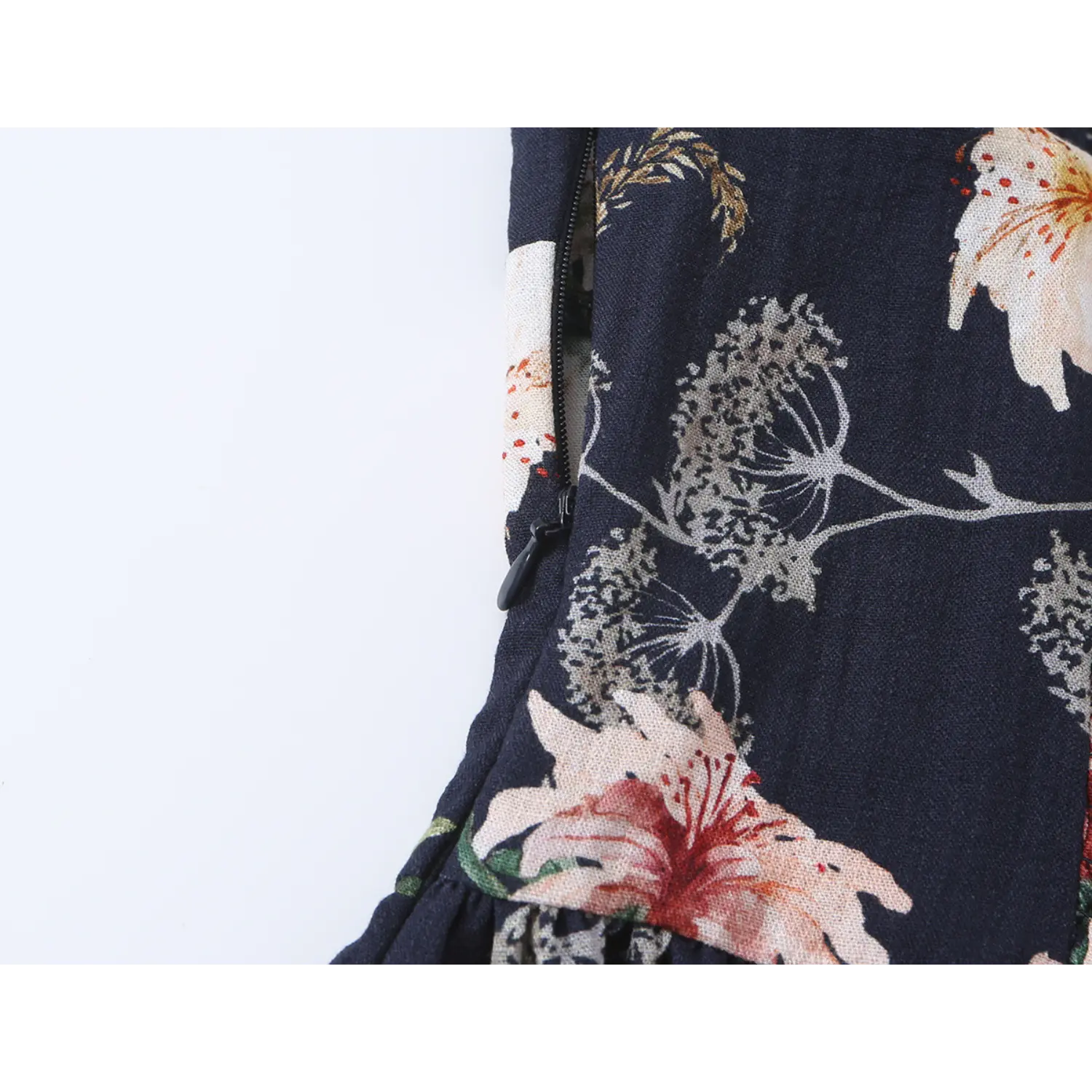 Close-up of side invisible zipper on dark navy floral print spaghetti strap dress