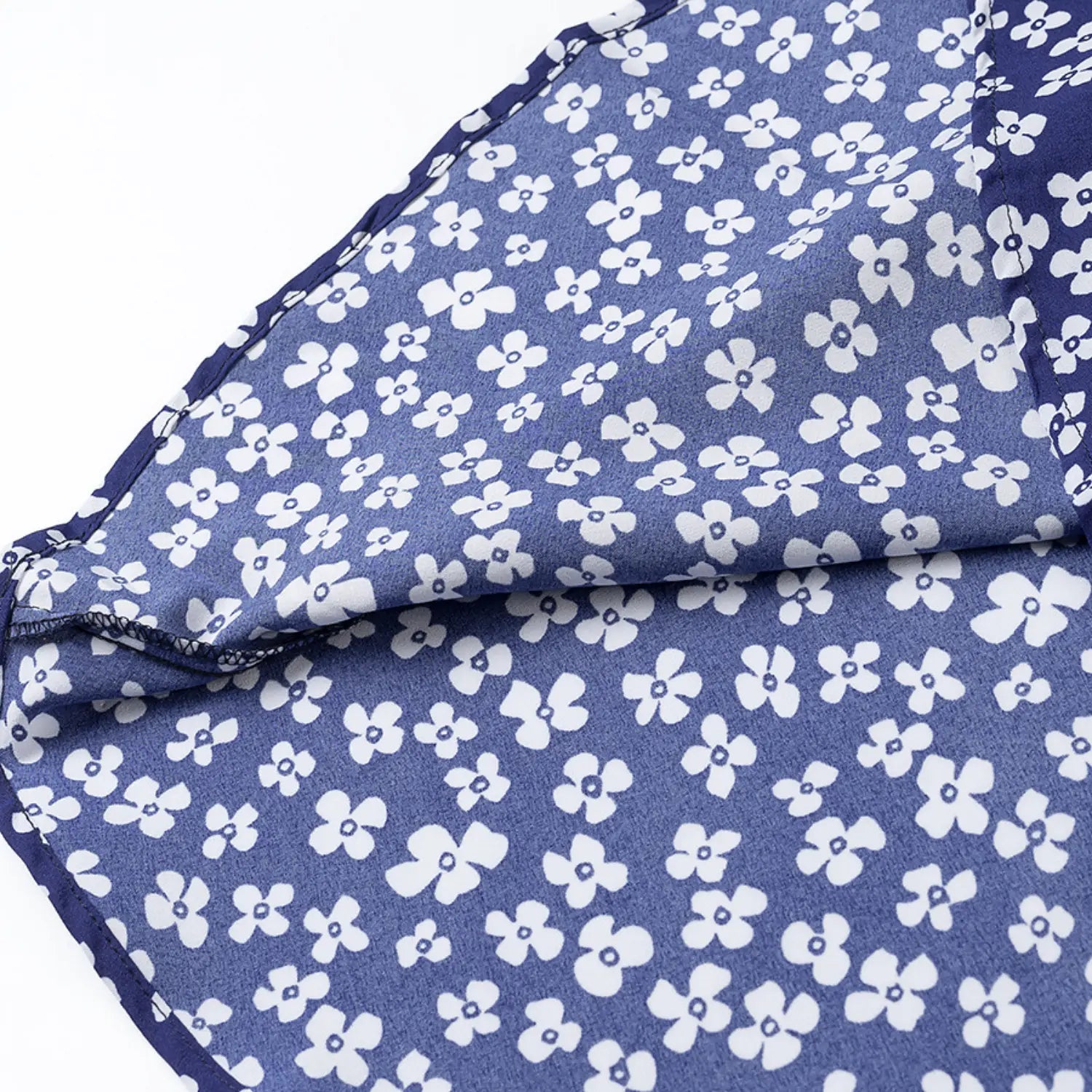 Close-up of the inner lining and hem stitching on the navy blue floral dress