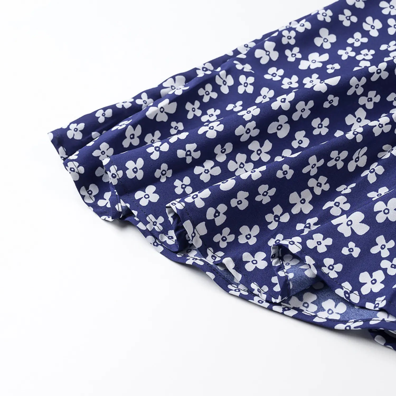 Close-up of the finished hem and double stitching on the navy blue floral dress
