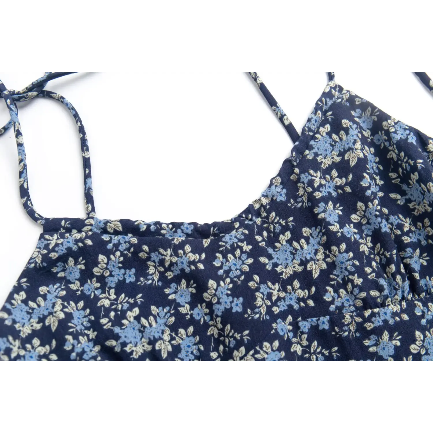 Close-up of the gathered stitching at the bust of the navy blue floral dress
