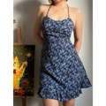  Lifestyle shot of model wearing the navy blue floral halter dress, showing the front silhouette