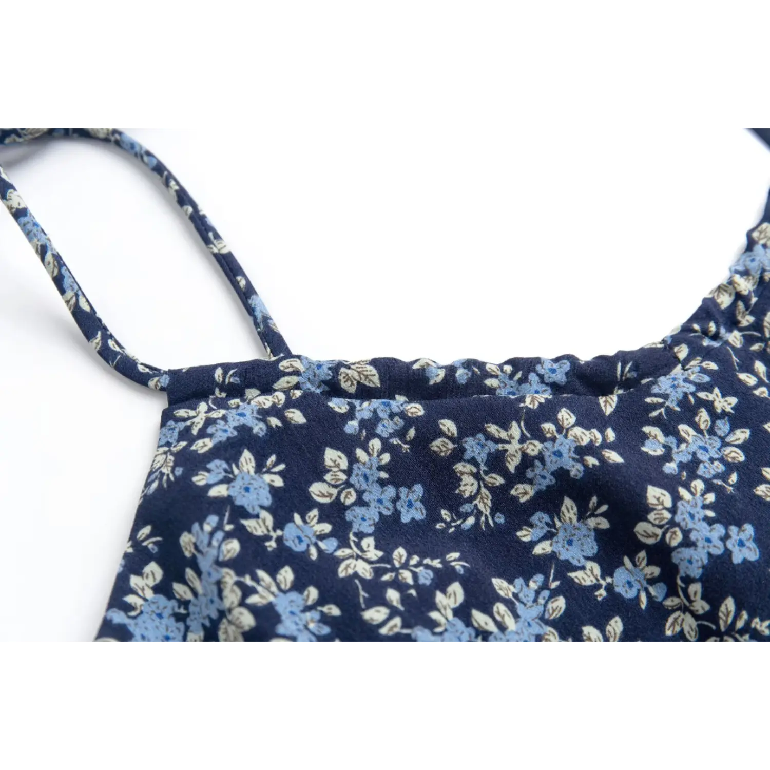 Close-up of the adjustable tie straps on the navy blue floral dress