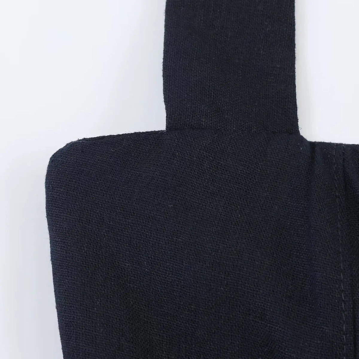 Macro close-up of navy woven fabric texture on halter mini dress