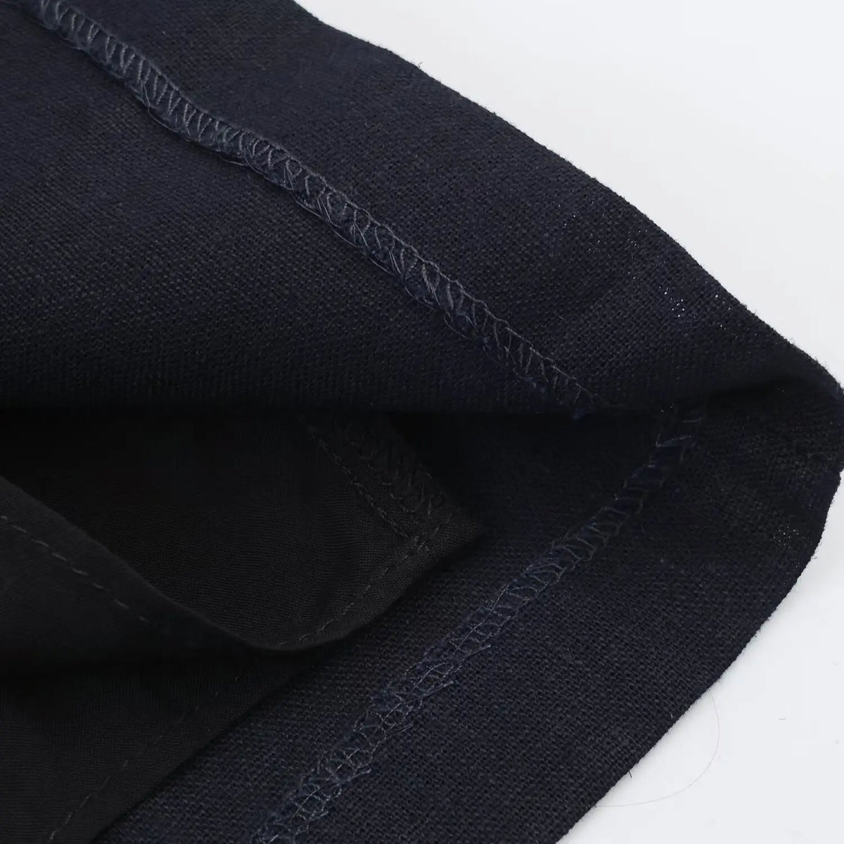 Macro view of inner seam stitching and lining fabric of navy halter mini dress