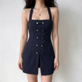 Model wearing navy halter mini dress, square neck, gold button decorations, front slit, fitted silhouette