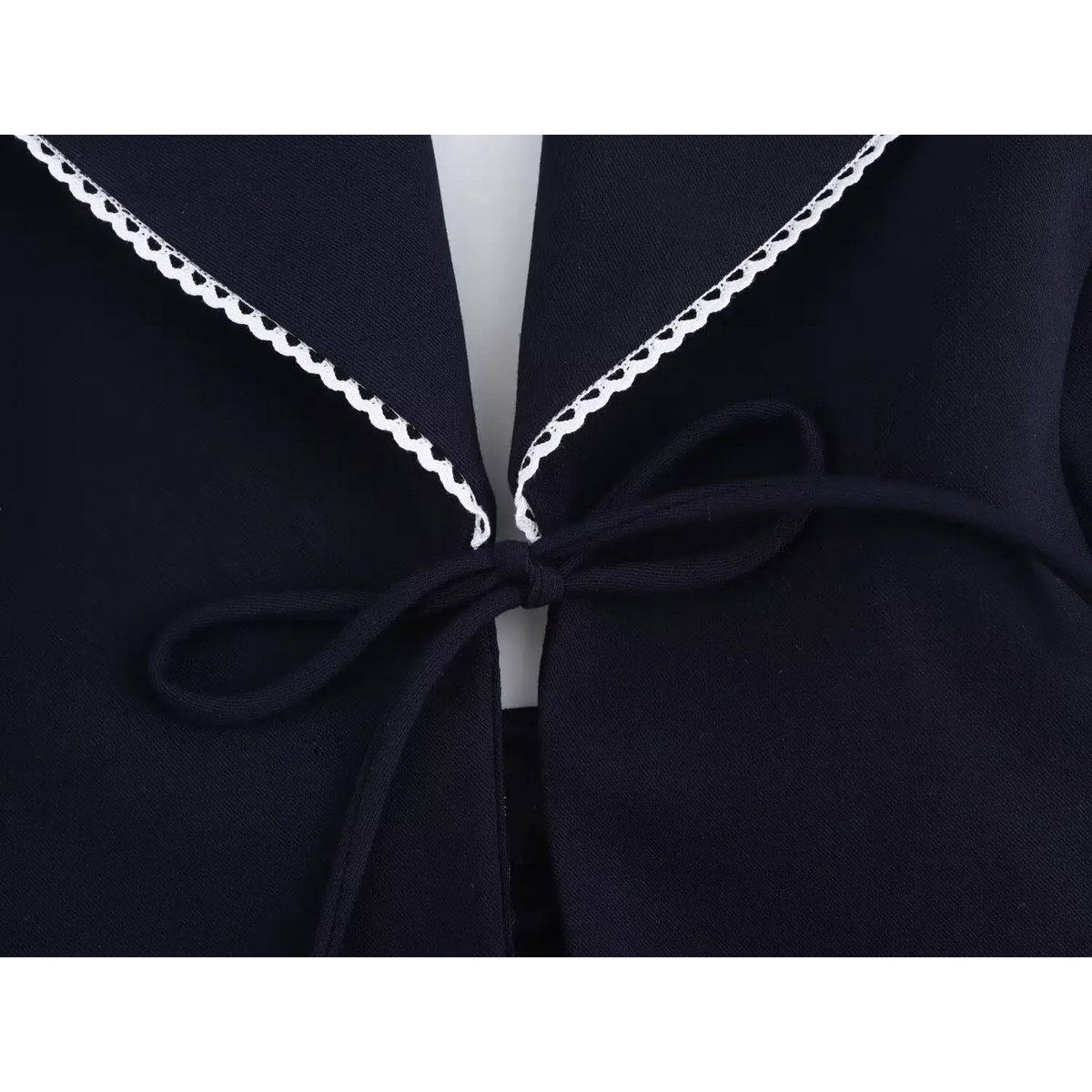 Close-up of front tie bow and scallop trim