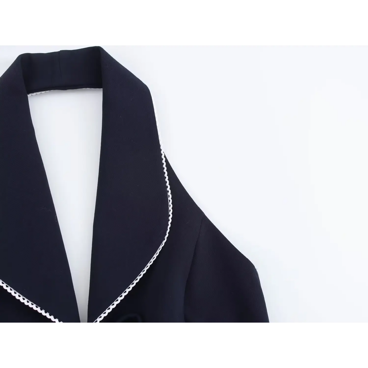 Close-up of white scallop trim along collar edge