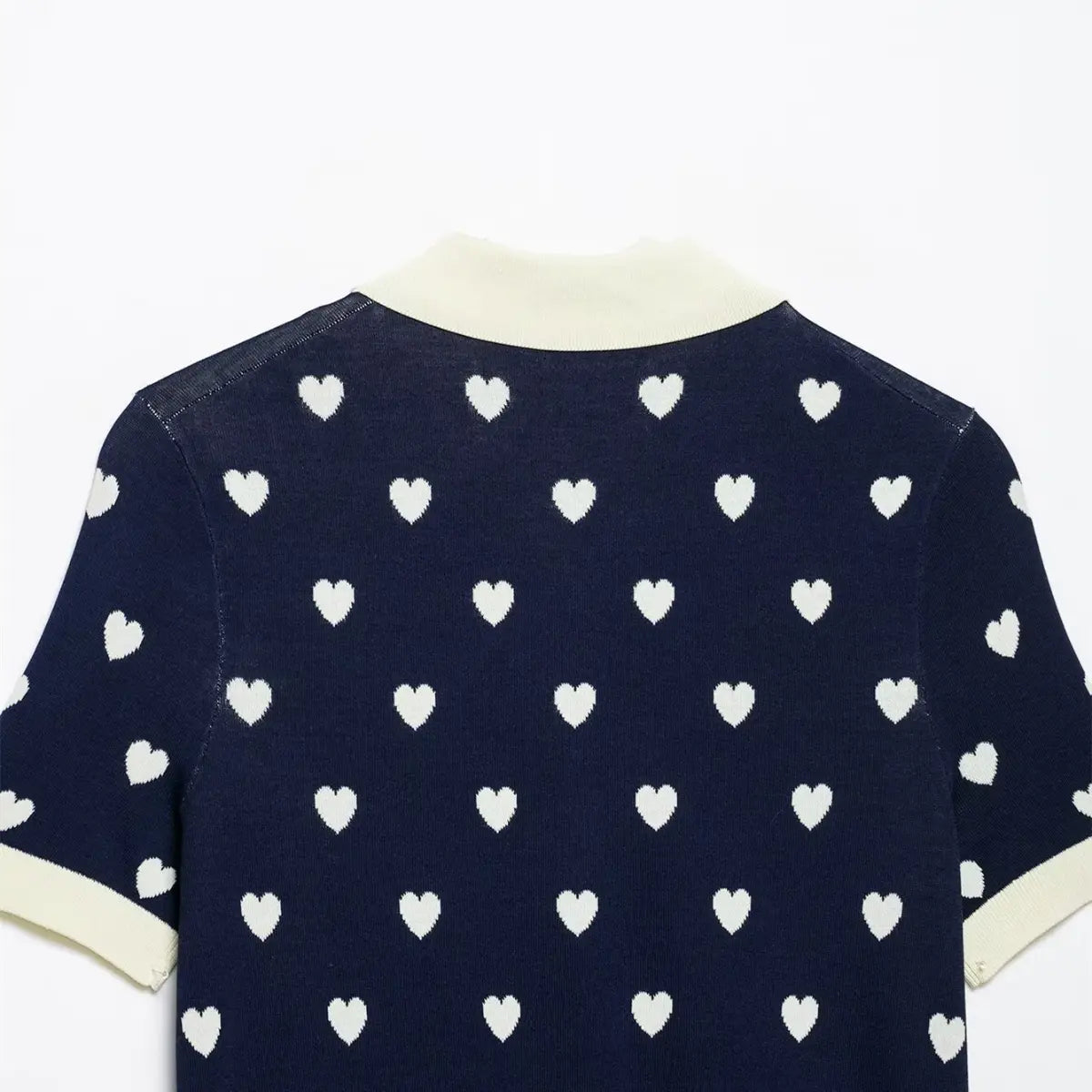 Back view of navy heart print knit polo top, focusing on the knit texture and heart pattern.