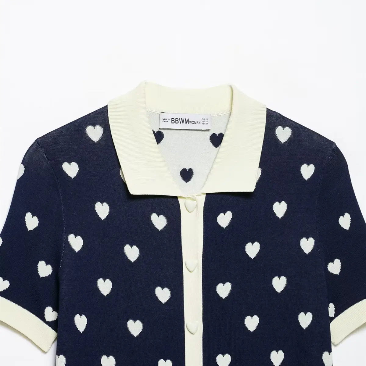 Close-up of the inner label on navy heart print knit polo top, showing brand tag and collar.