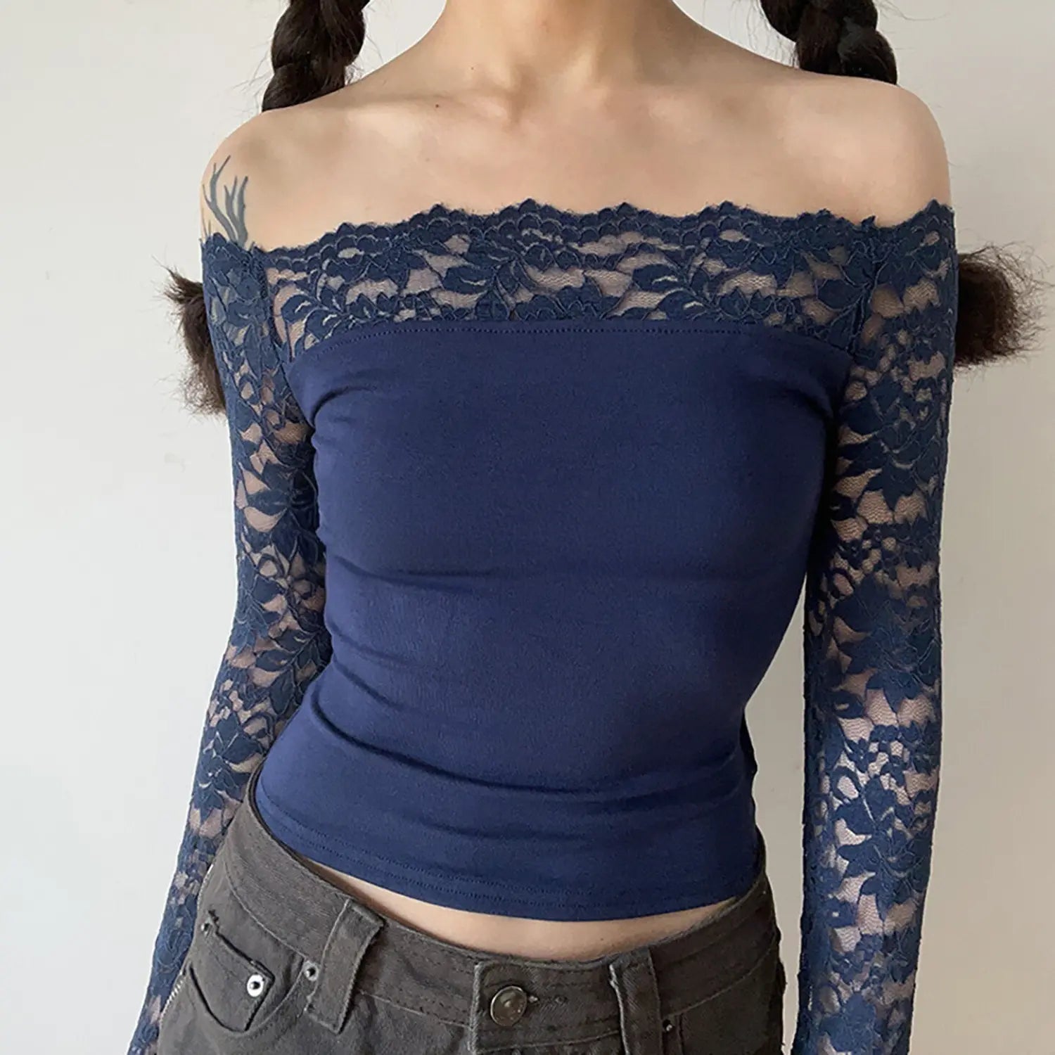 Model front shot navy blue off‑shoulder floral lace long sleeve cropped blouse