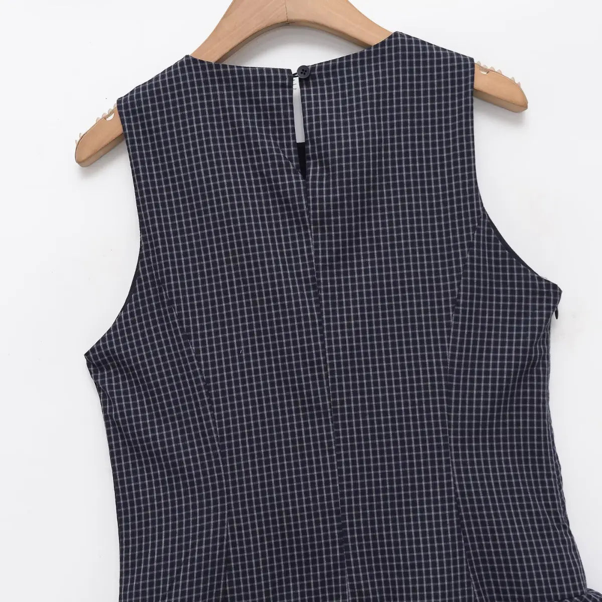 Back view of navy plaid dress, showing the center back keyhole closure with button