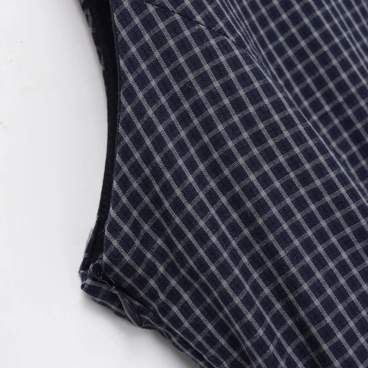 Close-up of the side zipper on the navy plaid dress