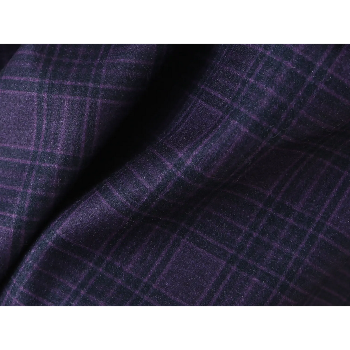 Close-up texture shot of navy plaid woven fabric for halter mini dress, showing soft tartan pattern and fabric drape