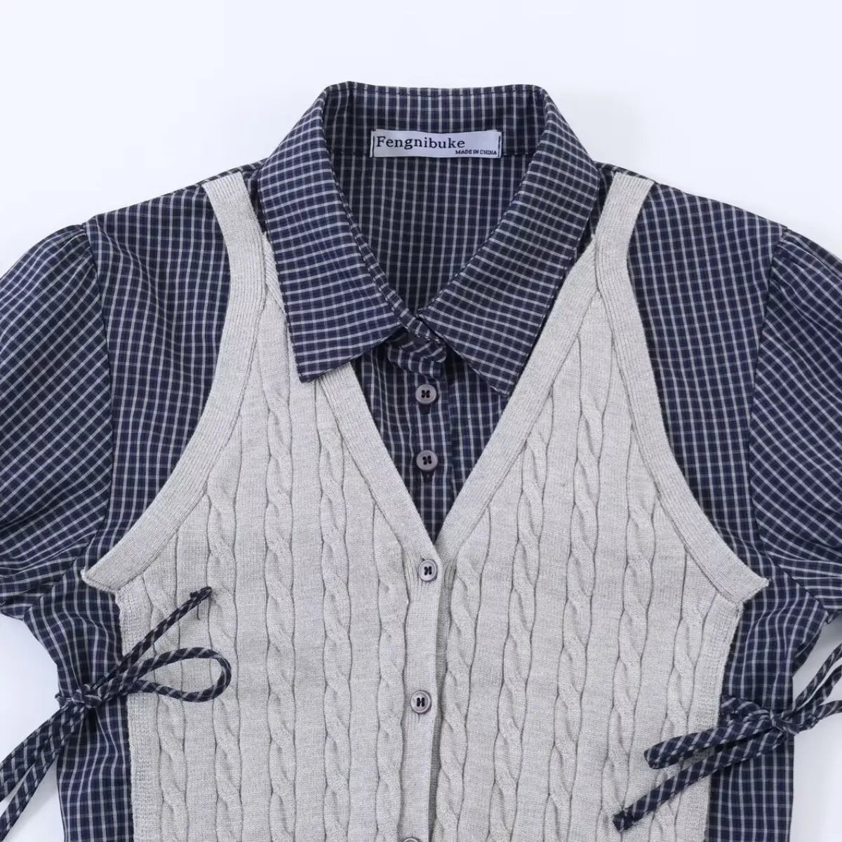 Full front view of the two-piece navy plaid shirt and grey knit vest, showing brand label and tie details