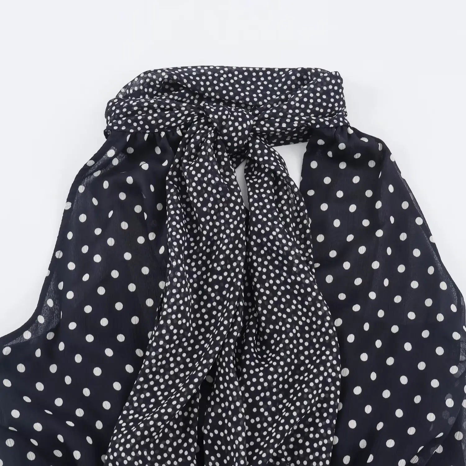 Back partial view of navy polka dot halter maxi dress, knotted tie halter neck design