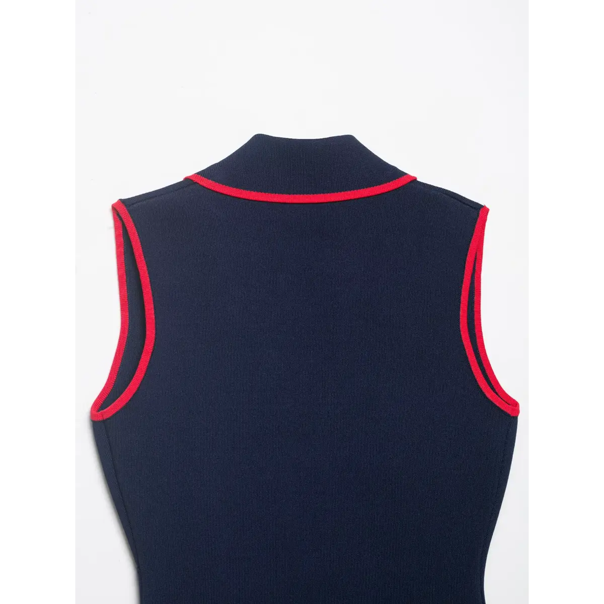 Navy knit vest laid flat, showing back silhouette and red piping along the neckline