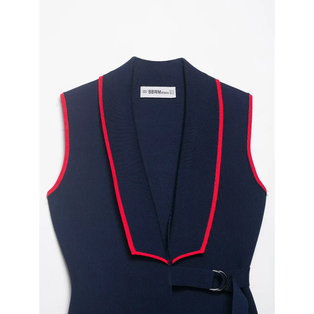 Navy knit vest laid flat, showing full front silhouette and red trim