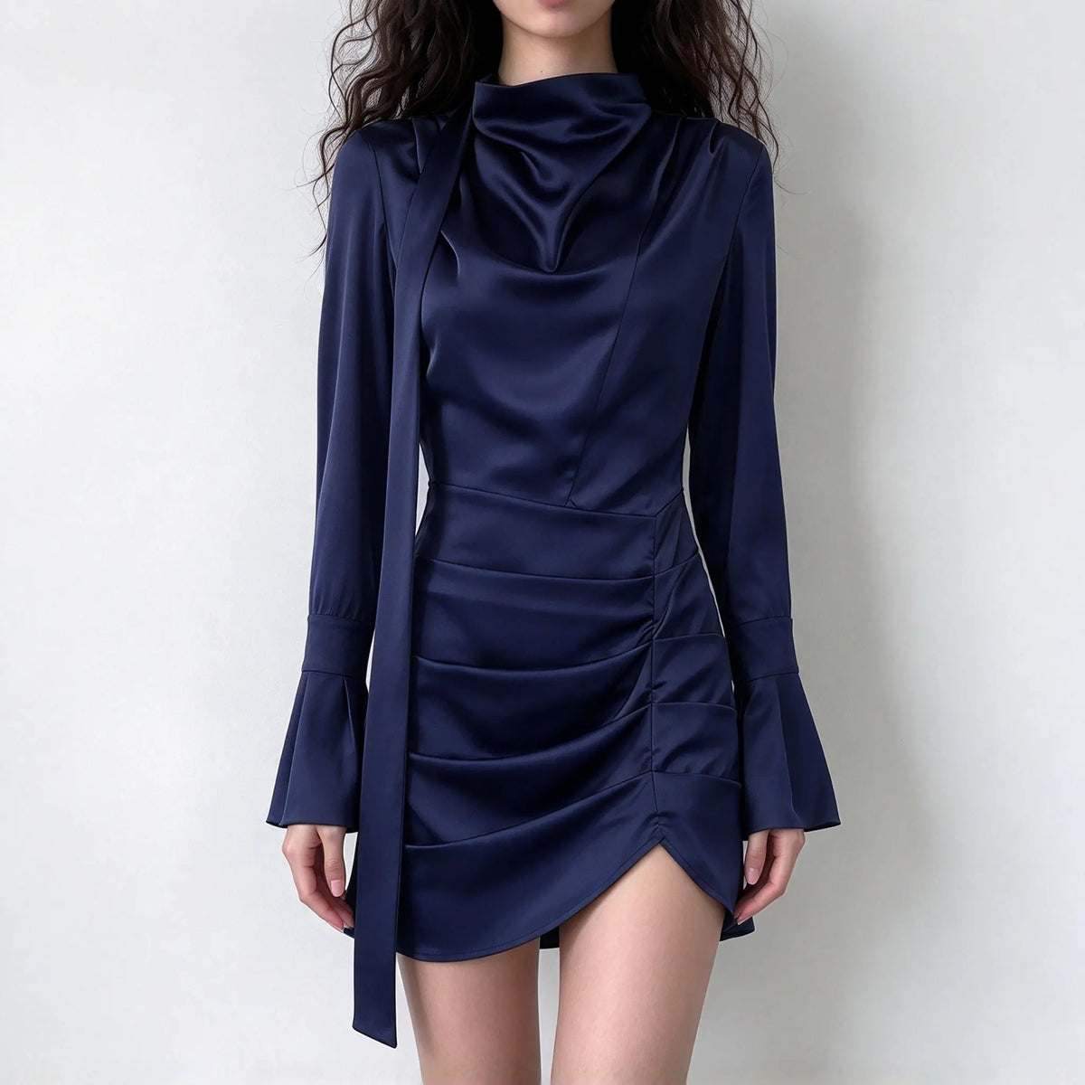 Model wearing navy satin cowl neck tie draped mini dress, front view