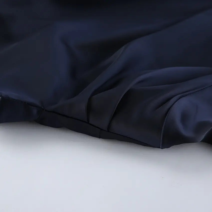 Close-up of draped satin skirt