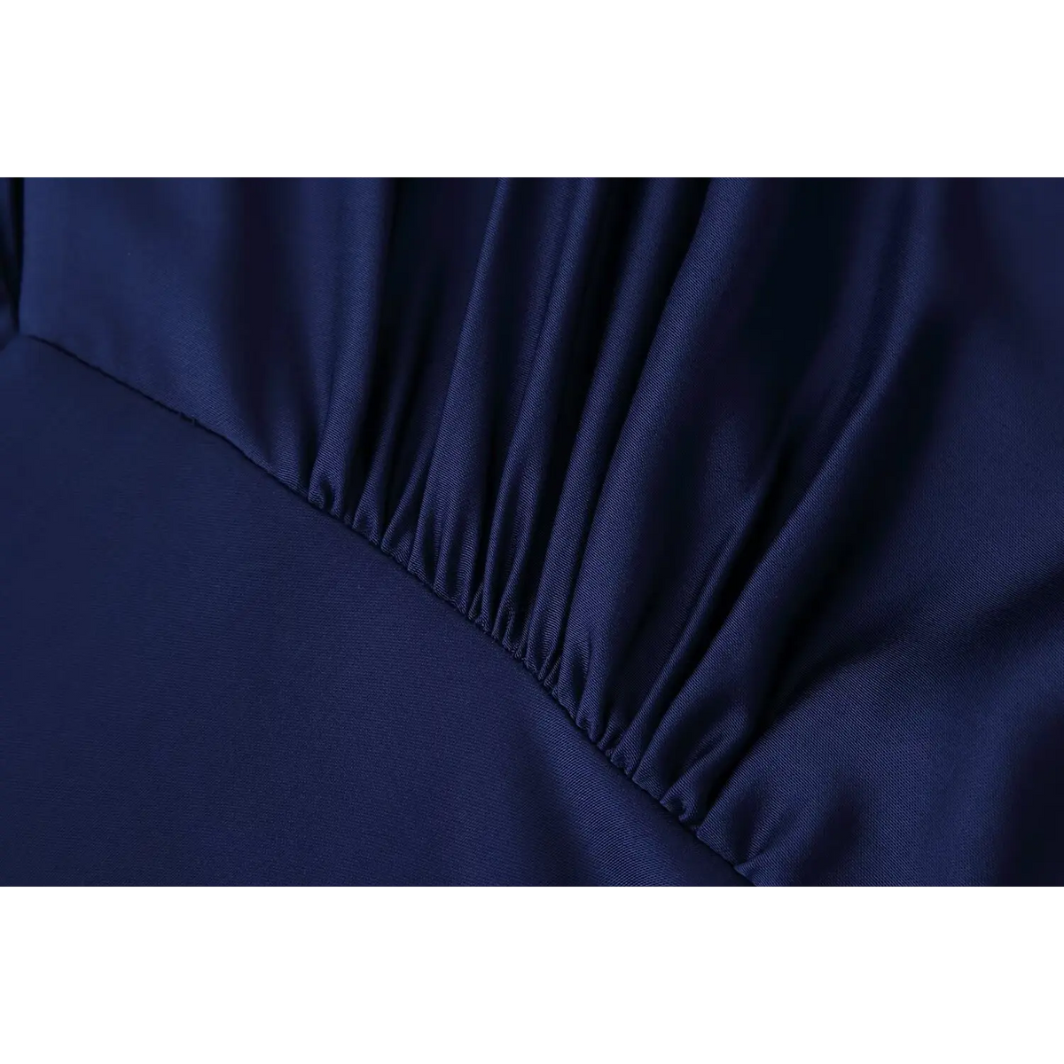 Close-up of gathered waist seam on satin dress
