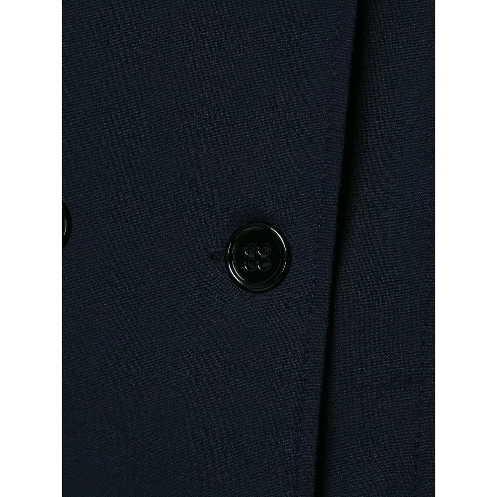 Close-up of single glossy button and stitching