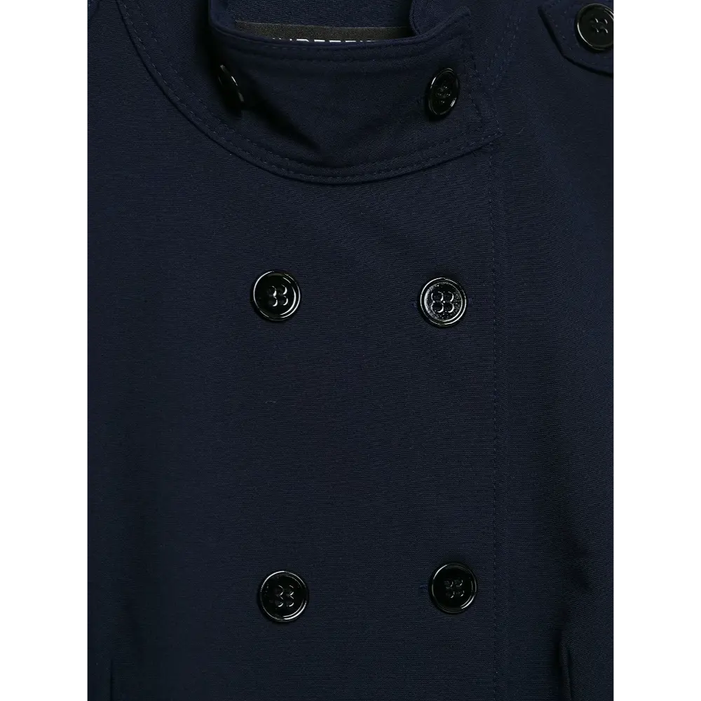 Close-up of glossy black buttons on navy twill