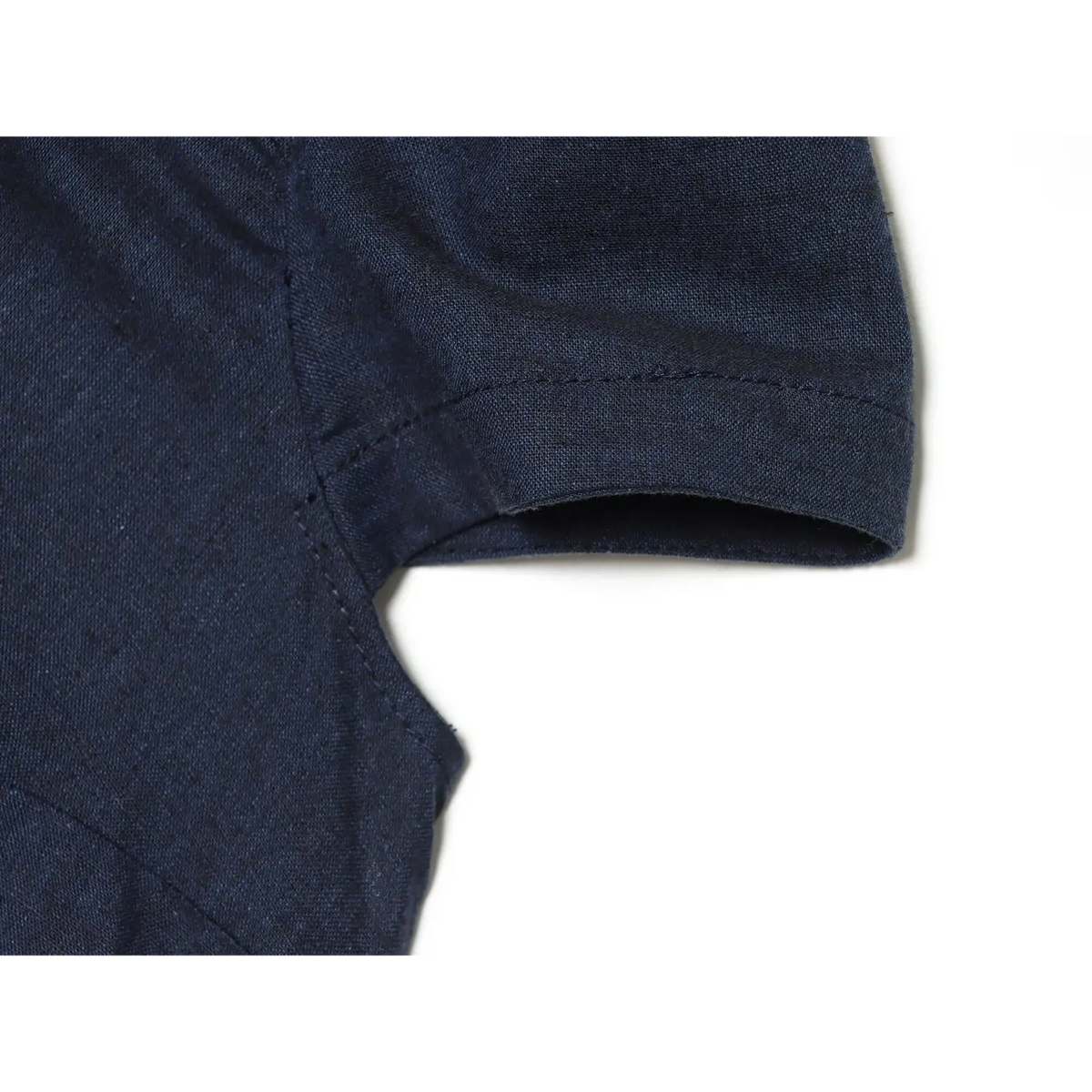 Close‑up of puff short sleeve stitching detail on navy blue chinese‑style mini dress