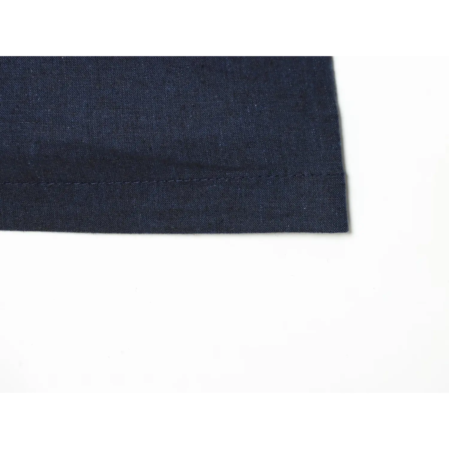 Close‑up of neat hem stitching for navy blue chinese‑style mini dress